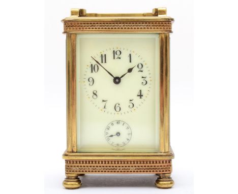 An early 20th century brass alarm carriage clock, with 8 day movement striking on bell. 13cm tall, with key. 