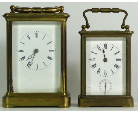 An early 20th century brass carriage alarm clock, the 8 day movement striking on bell, together with a later French example, 