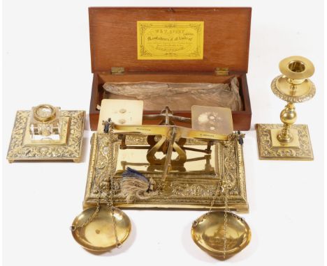 A brass set of scales with cast base, 21 x 14cm, a cased set of brass Avery scales, a brass inkwell and a brass candlestick (