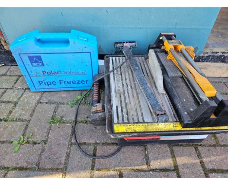 A Polar Professional pipe freezer kit, various pumping tools, an electric tile cutter and a manual tile cutter All electrical