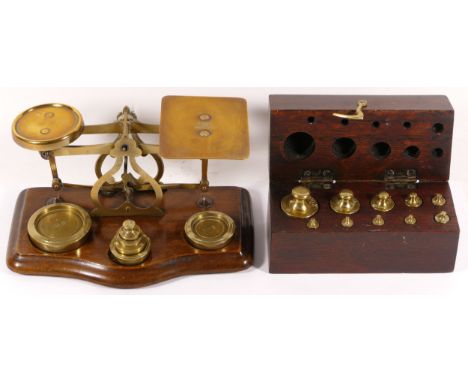 A set of early 20th century postal scales, together with a boxed set of additional postal weights. (2) 