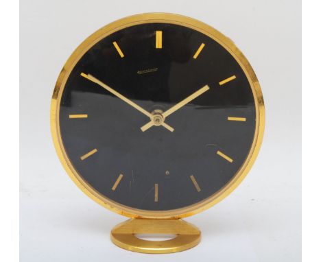 Jaeger LeCoultre, a circular brass desk clock, signed, with batons maker hours with dual batons at 12, 18cm diameter, raised 