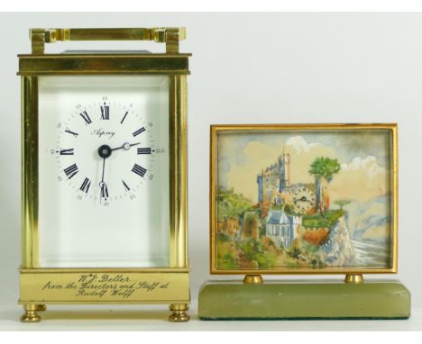 An English 8 day brass carriage clock, retailed by Asprey, together with a Swiss bedside clock on onyx base. (2) 