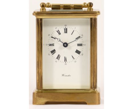 A French brass carriage clock, having a jewelled 8 day movement, boxed with key. 12cm tall. 