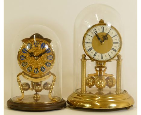Two mid 20th century German anniversary clocks, having manual wind movements, brass cased with glass dome. (2) 