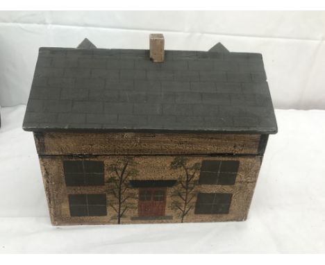 A wood house tea caddy