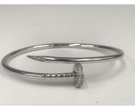 An 18ct white gold diamond encrusted bangle