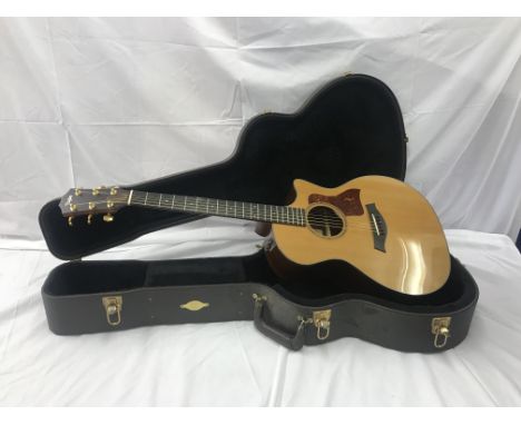 A Taylor semi-acoustic guitar hand-built in a Taylor fitted case: Mod 714CE, Serial No 20050615128 CONDITION REPORT: The guit
