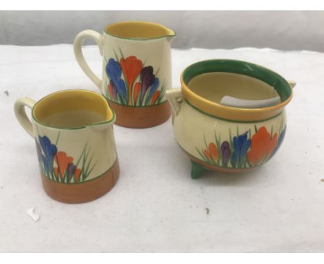 Two Clarice Cliff crocus pattern jugs; together with a Clarice Cliff crocus pattern cauldron