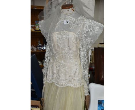 A DROP WAISTED 1980's STYLE CREAM/CHAMPAGNE COLOURED WEDDING DRESS WITH TUILLE UNDERSKIRT, approximate UK size 10, applique b