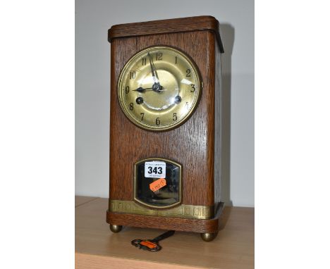 A JUNGHANS TABLE CLOCK, a plane oak case, striking gong, half hour and hour, supported by four ball feet, gilt dial, stamped 