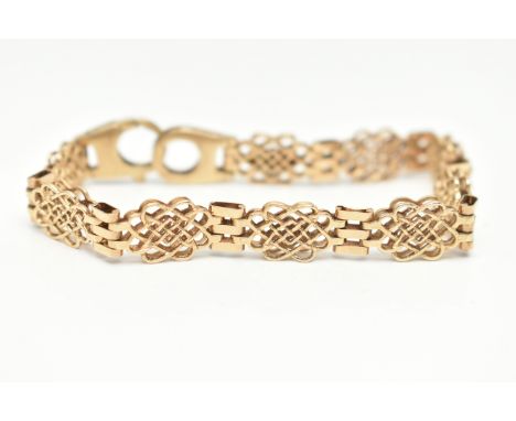 A 9CT GOLD FANCY LINK BRACELET, open work links interspaced with three bar links, fitted with a large lobster clasp, hallmark