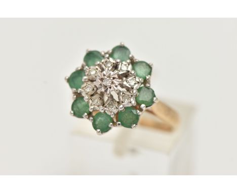 A 9CT GOLD EMERALD AND DIAMOND CLUSTER RING, tiered cluster set with nine illusion set single cut diamonds, in a surround of 