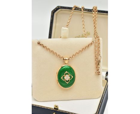 AN 18CT GOLD DIAMOND AND ENAMEL LOCKET, the oval locket with green enamel front, a quatrefoil design set centrally with four 