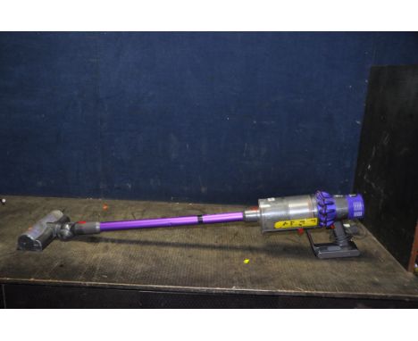 A DYSON V10 ANIMAL CORDLESS VACUUM CLEANER with power supply (PAT pass and working) (condition report: few dents to pipe)