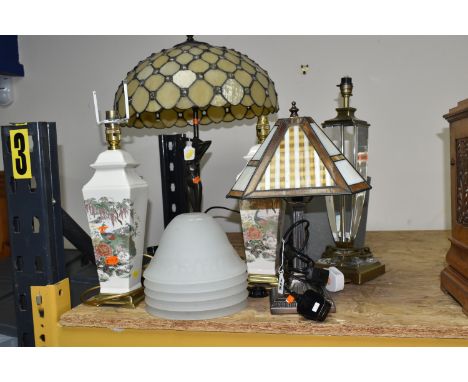 A GROUP OF TABLE LAMPS, comprising a modern figural lamp with leaded effect shade, total height approximately 60cm, a smaller