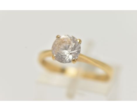 A YELLOW METAL TOPAZ RING, set with a circular cut colourless topaz, in a four claw setting, pinched shoulder leading onto a 