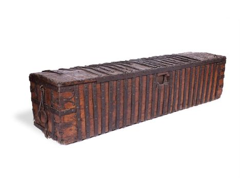 AN OAK AND IRON-BOUND CHEST POSSIBLY 14TH CENTURY  With a slightly domed hinged lid and iron fixings and loops to the ends, s
