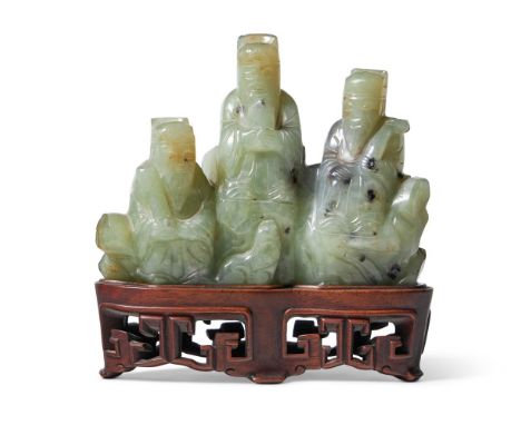 A CHINESE CELADON AND BLACK JADE GROUP OF THREE IMMORTALS LATE QING DYNASTY 11cm high, fitted wood stand  Condition Report:  