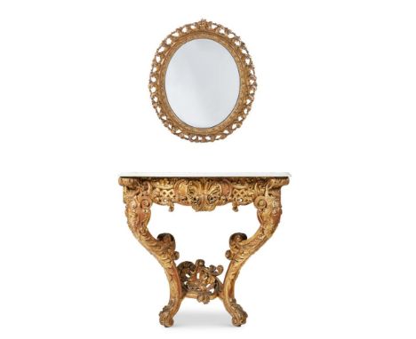 A PAIR OF VICTORIAN GILTWOOD SERPENTINE CONSOLE TABLES MID-19TH CENTURY Each with a white marble top, boldly carved with foli