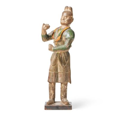 A LARGE SANCAI GLAZED POTTERY FIGURE OF A CAMEL GROOM TANG DYNASTY (618-907 AD)  the standing figure modelled with the torso 
