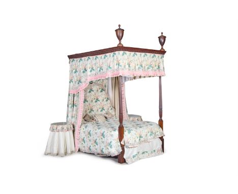 A MAHOGANY FOUR POST BED OF GEORGE III STYLE MODERN  the foliate-carved canopy with large urn finials above turned reeded pos