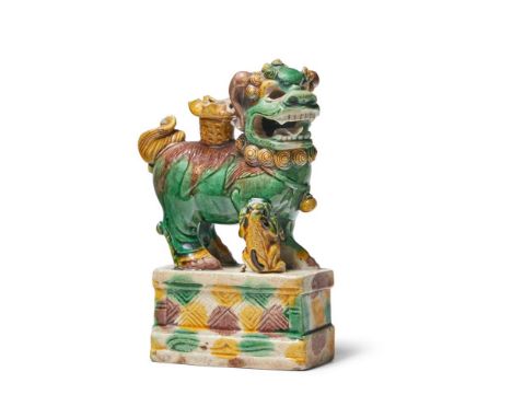 A SANCAI-GLAZED MODEL OF A BUDDHIST LION AND PUP KANGXI (1662-1722) on raised base 15cm high   Condition Report:  chippedhead