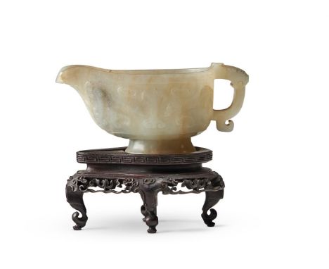 A CHINESE PALE CELADON JADE 'ARCHAISTIC' RITUAL POURING VESSEL, GONG 17TH/18TH CENTURY carved with taotie masks on a cross-ha