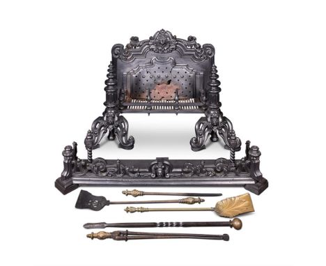 A VICTORIAN CAST IRON FIRE BASKET  CIRCA 1860 The shaped back centred by a foliate mask and with tapering front posts with pi