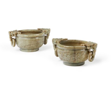 A LARGE PAIR OF CELADON JADE CENSERS CHINESE, EARLY 20TH CENTURY Carved with taotie masks in relief and flanked with two susp