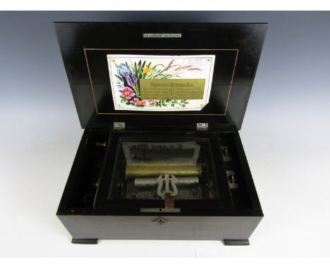 A Victorian Swiss made National Music Box, playing eight airs, in a scumbled wooden case with string inlay and a decorative d