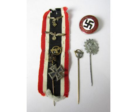 A German Third Reich NSDAP party members' badge and various stick pins and ribbon badges