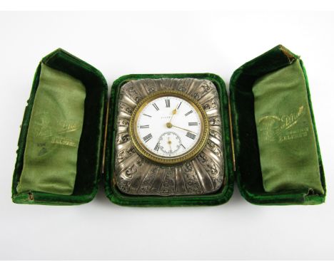 A late Victorian silver-cased travelling boudoir timepiece, having a French movement with enamel face, the latter set in an e