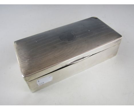 A George V silver table cigarette box, of rounded rectangular form, the cover having engine-tuned and banded decoration surro