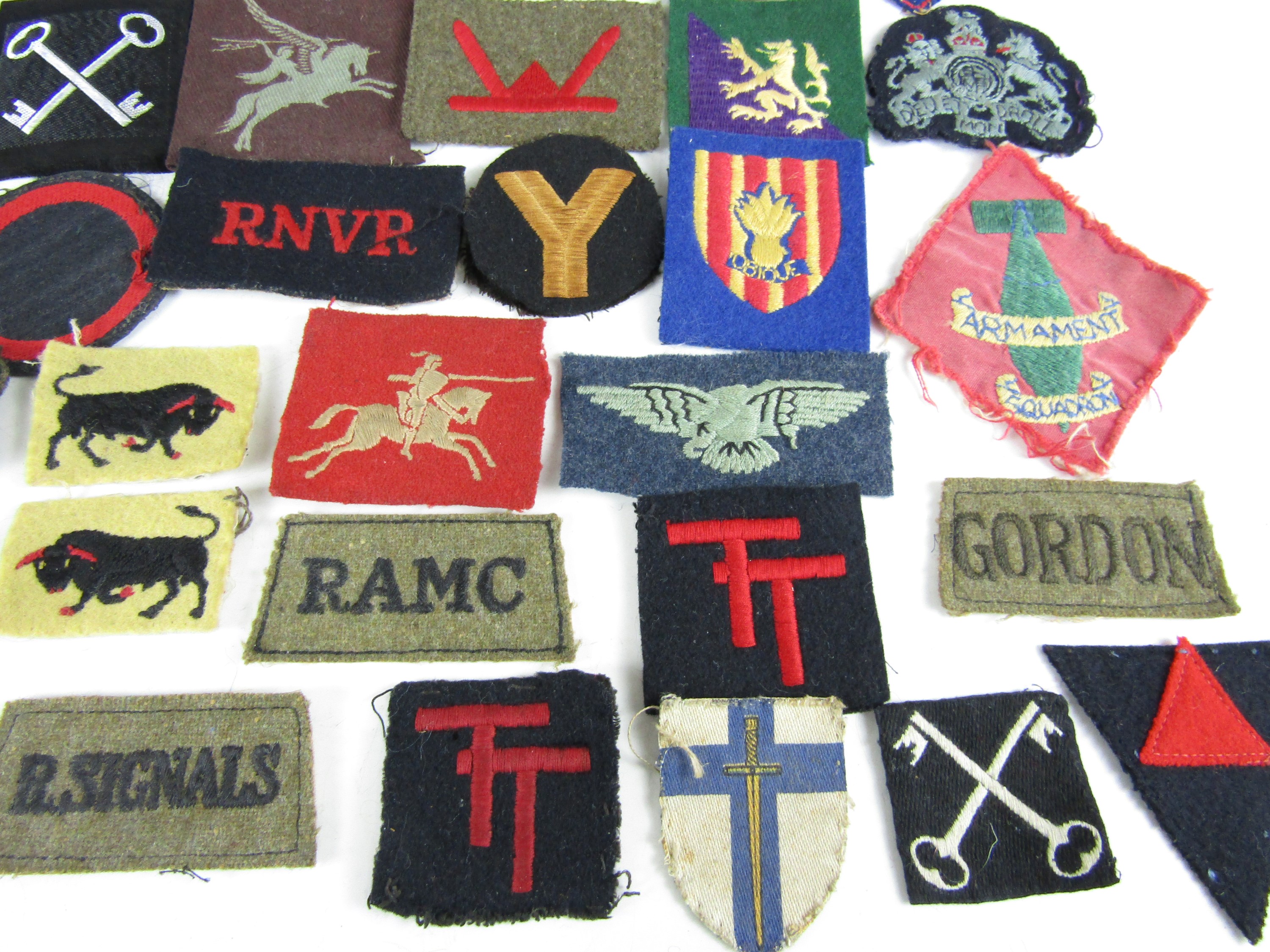 A quantity of Second World War and later British military cloth insignia