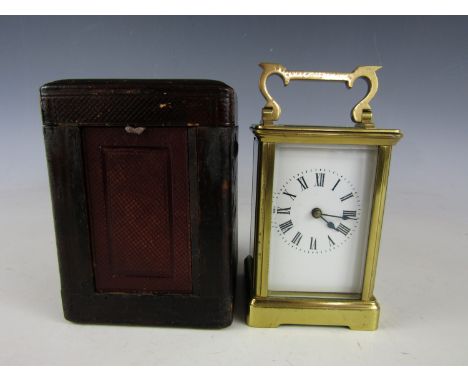 A late 19th / early 20th Century carriage clock, in Morocco leather covered transit case, timepiece 15 cm including swing han