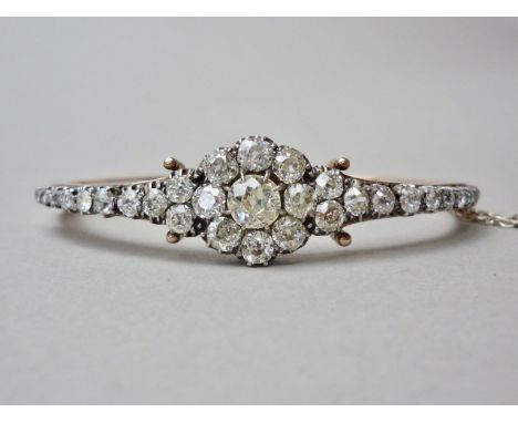A Belle Époque diamond encrusted and hinged bangle, the diamond brilliants of approximately 4.80ct total diamond weight, with
