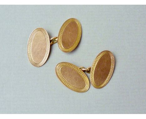 A gentleman's pair of 9ct gold cufflinks, of oval shape with an engine turned border, 7.3g