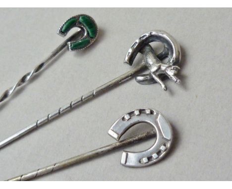 Three Victorian white metal lucky horseshoe stick pins, one set with polished malachite, test as silver