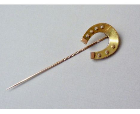 A Victorian yellow-metal stick pin, the terminal modelled in the form of a horseshoe, tests as gold, 4.2g