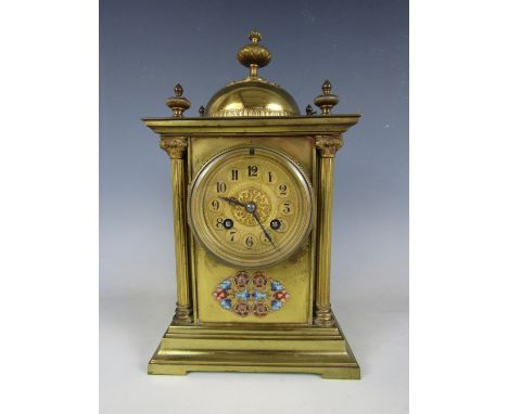 A late 19th Century French mantel clock, in an upright architectural gilt brass case with domed surmount, the latter and the 