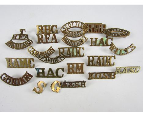 A quantity of British Army brass shoulder titles including T-RFA-HIGHLAND