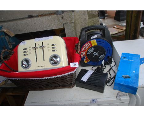 An extension reel, toaster, Halfords mains adapter, basket etc.