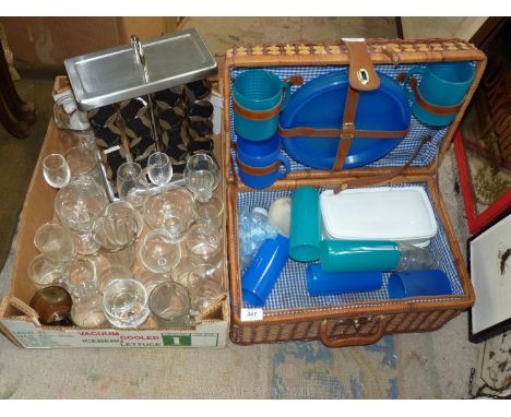 A box of glass and a spice rack plus a wicker picnic basket.