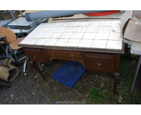 A tiled top washstand with drawers, 47" x 22" x 29".