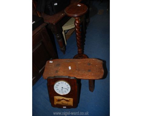 A small bench, plant stand and a clock.