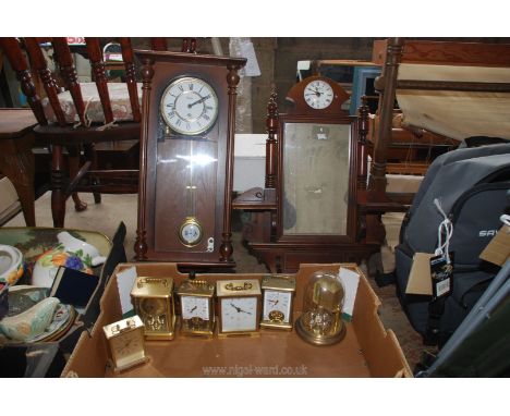 A quantity of miscellanea including carriage clocks, a wall clock and a mirror with a clock.
