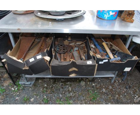 Three tools, Stilsons, pick axe head, etc.