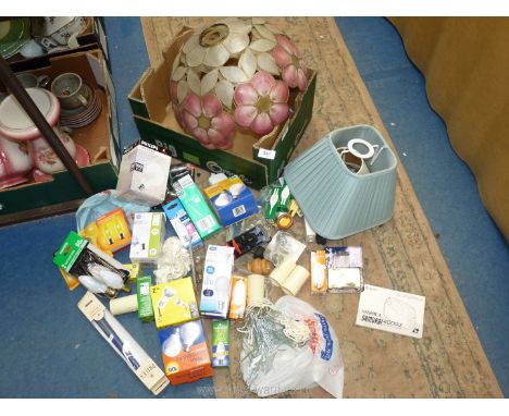 A box of lamp shades, light bulbs, curtain hooks, etc.