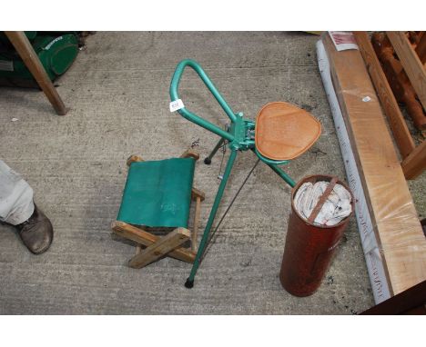 A vintage fire blanket in metal tube, shooting stick and a small stool.